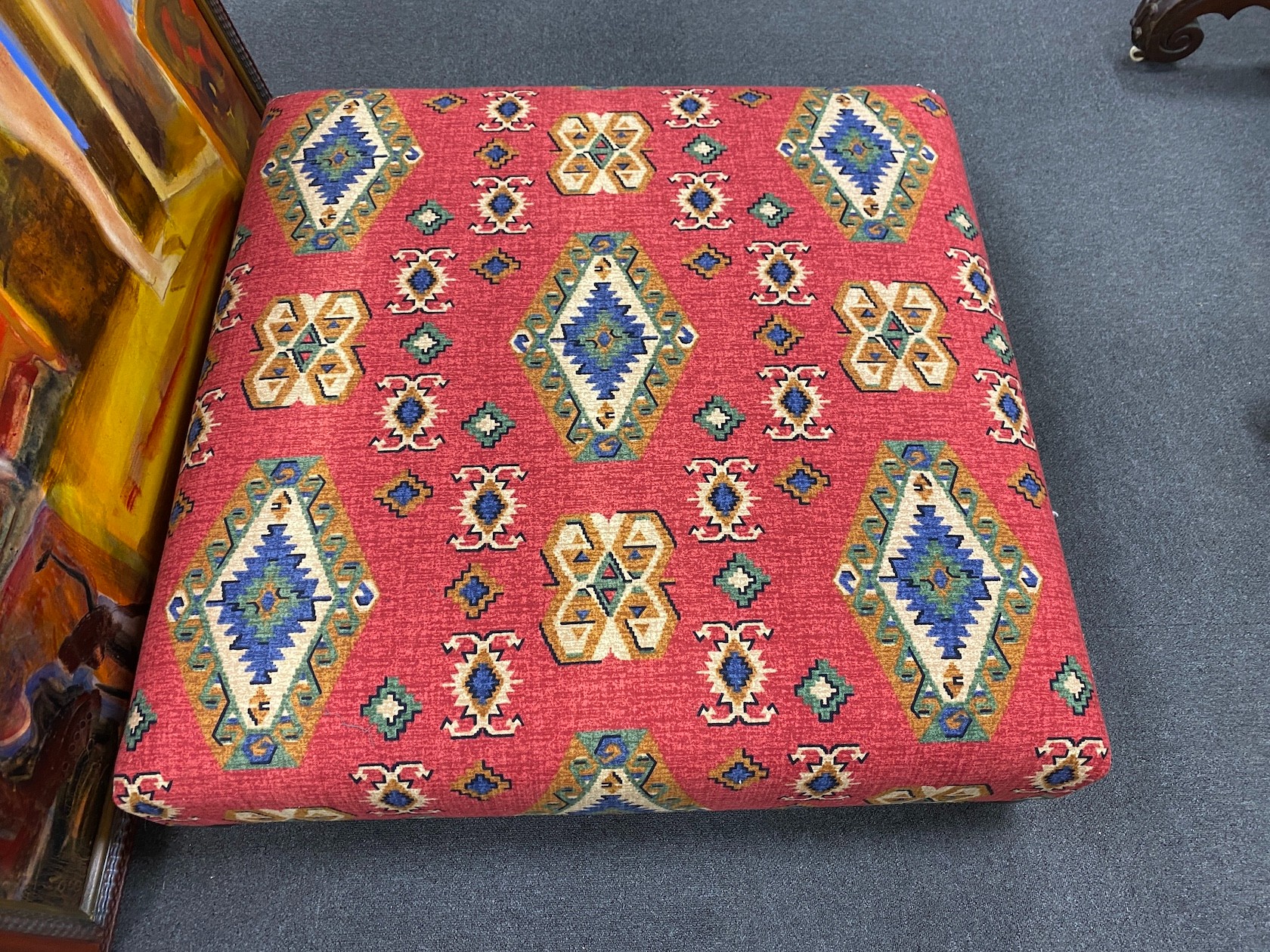 A large square contemporary footstool upholstered in red ground Kilim style fabric, width 102cm, height 27cm